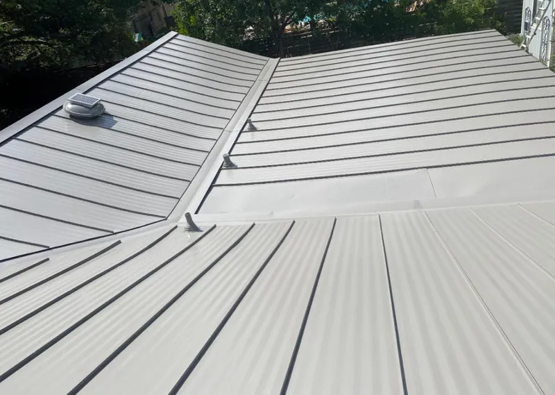 Solar attic fan installed on a metal roof for Roof Ventilation in New Hyde Park